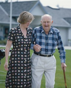 woman assists older man